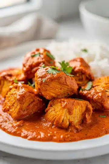 Crockpot Chicken Tikka Masala 10 Creamy crockpot chicken tikka masala with naan bread and fresh cilantro garnish.