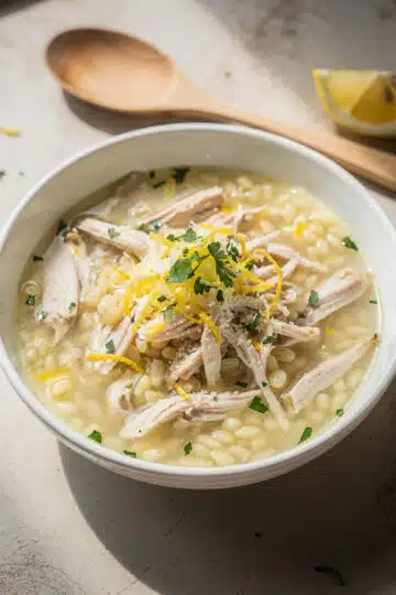 Lemon Chicken Orzo Soup 12 Creamy lemon chicken orzo soup recipe in a rustic white bowl