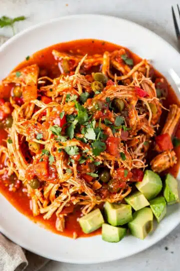 Slow Cooker Salsa Chicken 14 Slow cooker salsa chicken in a warm tortilla with avocado and cilantro