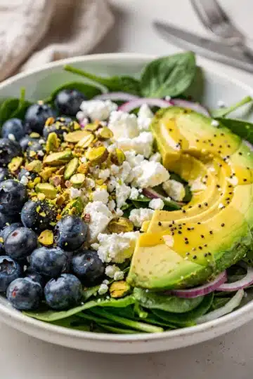 Blueberry Pistachio Spring Salad 14 Fresh spring salad with blueberries pistachios feta and lemon poppy seed dressing