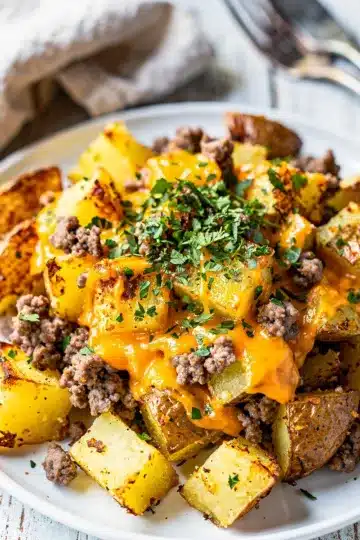 Cheesy Corned Beef Hash 12 Cheesy corned beef hash with crispy potatoes and melted cheddar topped with eggs