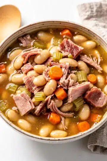 Ham Bean Soup 13 Hearty ham and bean soup recipe in a rustic ceramic bowl.