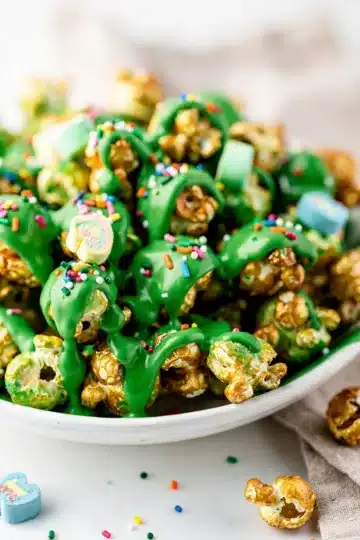 Leprechaun Popcorn 12 Leprechaun Popcorn recipe with green toffee and rainbow sprinkles in bowl.
