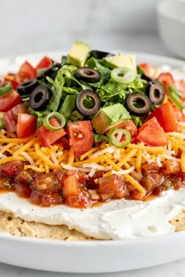 Loaded Taco Dip 11 Layered taco dip with beans cheese salsa lettuce tomatoes olives and chips