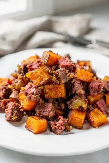 Corned Beef Hash Sweet Potatoes 12 Crispy corned beef hash with sweet potatoes and red peppers in cast iron skillet