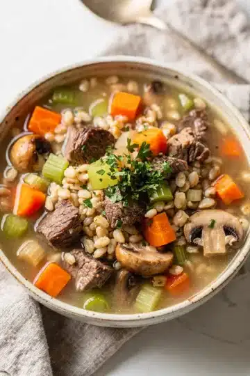 Slow Cooker Beef and Barley Soup 13 Hearty slow cooker beef barley soup with tender meat and vegetables in broth.