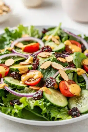 Spring Mix Salad with Honey Mustard Dressing 12 Fresh spring mix salad with creamy honey mustard dressing and colorful toppings.
