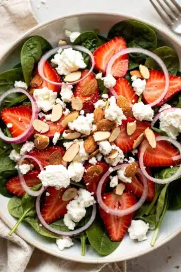 Strawberry Spinach Salad 11 Vibrant strawberry spinach salad with feta and almonds in a rustic bowl.