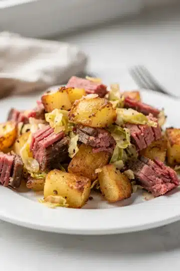 Corned Beef Hash with Cabbage 13 Crispy corned beef hash with cabbage and a fried egg in skillet