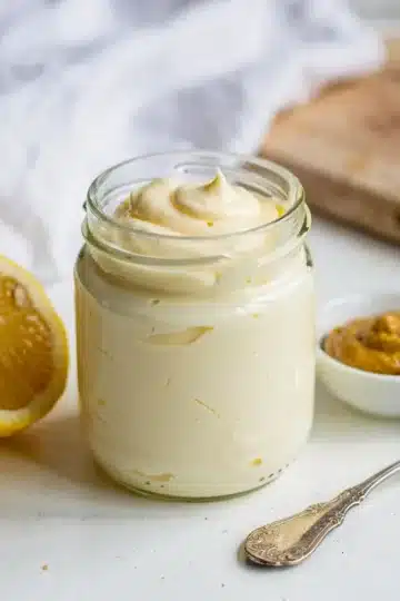 Homemade Mayonnaise 11 Creamy homemade mayonnaise recipe in a white bowl with olive oil drizzle