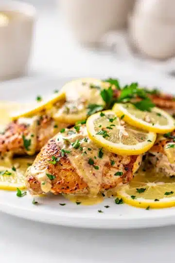 Creamy Lemon Chicken 13 Creamy lemon chicken recipe with golden pieces in a glossy velvety sauce.