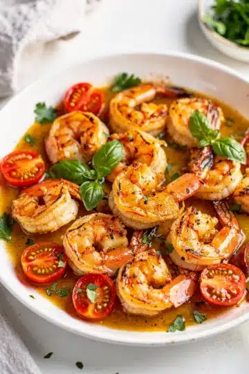 Garlic Butter Shrimp Skillet 12 Garlic butter shrimp skillet recipe with tomatoes and fresh parsley garnish