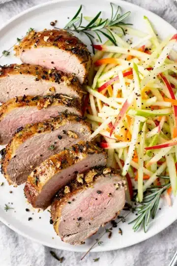 Herb Roasted Pork Tenderloin 14 Close up of juicy herb roasted pork tenderloin with crispy golden crust