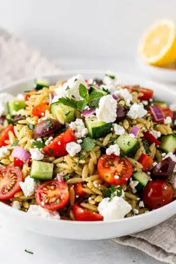 Mediterranean Orzo Salad 11 Colorful Mediterranean orzo salad with fresh vegetables olives and feta cheese