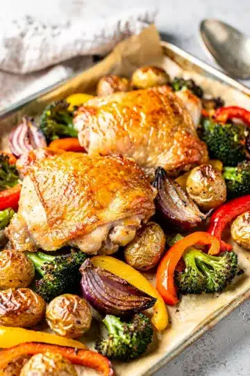 Sheet Pan Chicken and Veggies 11 Sheet pan chicken and veggies with roasted potatoes and colorful bell peppers.