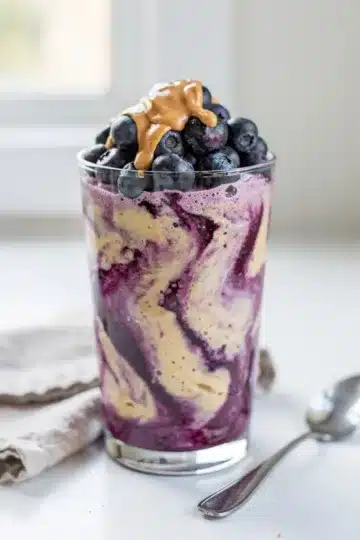 Blueberry Banana Protein Smoothie 15 Creamy blueberry banana protein smoothie topped with almond butter and chia seeds