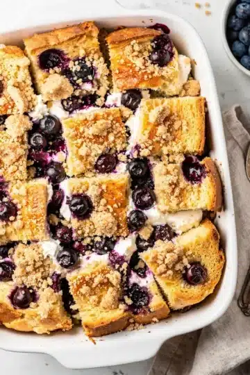 Easy Blueberry Cream Cheese French Toast Bake 14 Easy blueberry cream cheese French toast bake slice on a white plate.