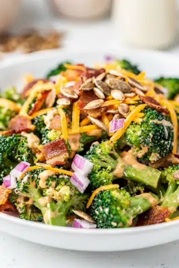 Crisp Broccoli Bacon Salad 11 Crisp broccoli bacon salad with cheddar and creamy dressing in bowl