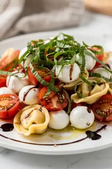 Caprese Tortellini Pasta Salad 13 Colorful caprese tortellini pasta salad with fresh mozzarella and basil.