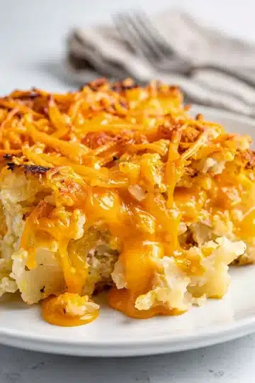 Cheesy Crockpot Cheesy Hashbrown Casserole 11 Creamy cheesy hashbrown casserole with crispy potato edges in close up