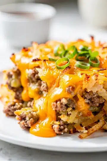Cheesy Crockpot Sausage Hashbrown Casserole 7 Cheesy crockpot sausage hashbrown casserole with golden crust and melted cheese.