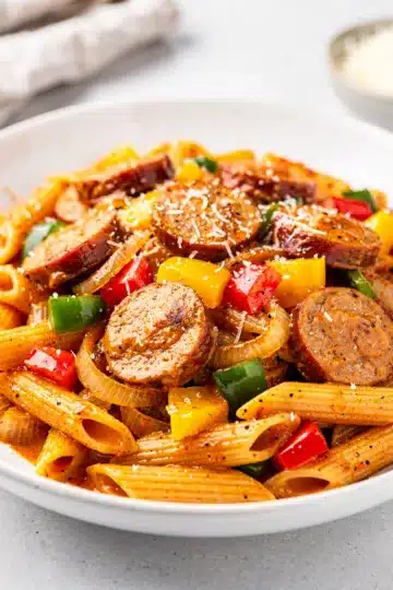 Easy Creamy Cajun Sausage Pasta 5 Creamy Cajun sausage pasta with penne in a glossy vibrant sauce.