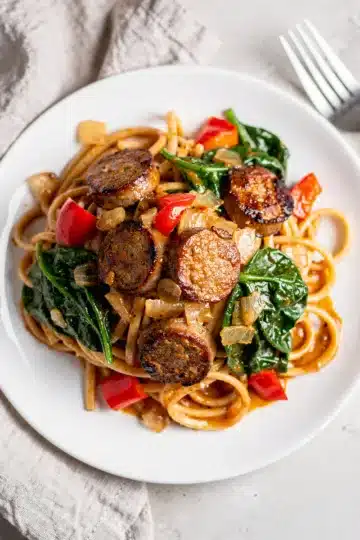Creamy Creamy Cajun Sausage Pasta 4 Creamy Cajun sausage pasta with penne, andouille, peppers, spinach, and Parmesan cheese.