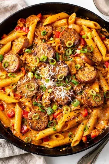 Skillet Creamy Cajun Sausage Pasta 1 Creamy Cajun sausage pasta with penne and peppers in a skillet.