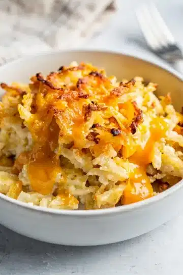 Creamy Crockpot Cheesy Hashbrown Casserole 13 Creamy crockpot cheesy hashbrown casserole with melted cheddar and cornflake crust.