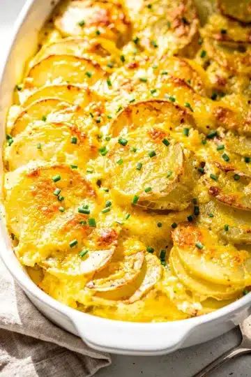 Creamy Cheesy Scalloped Potatoes 27 Creamy cheesy scalloped potatoes recipe in a rustic ceramic baking dish
