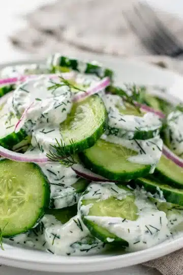 Fresh Creamy Cucumber Dill Salad 14 Creamy cucumber dill salad with yogurt dressing in a white bowl