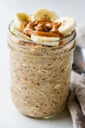 Creamy Peanut Butter Banana Overnight Oats 12 Creamy peanut butter banana overnight oats in a clear glass jar.