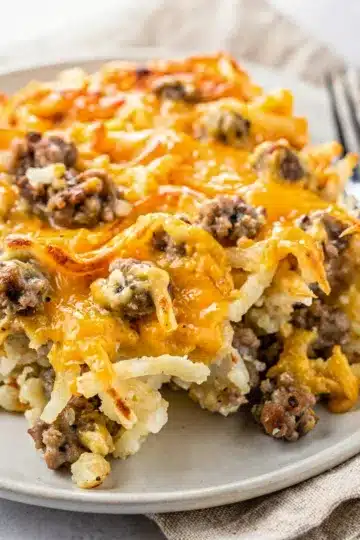 Creamy Crockpot Sausage Hashbrown Casserole 5 Creamy crockpot sausage hashbrown casserole with a golden cheese crust.