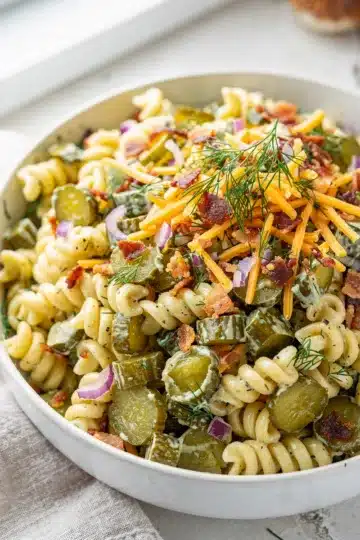Crisp Dill Pickle Pasta Salad 11 Creamy dill pickle pasta salad with rotini, cheddar, bacon, and fresh dill.