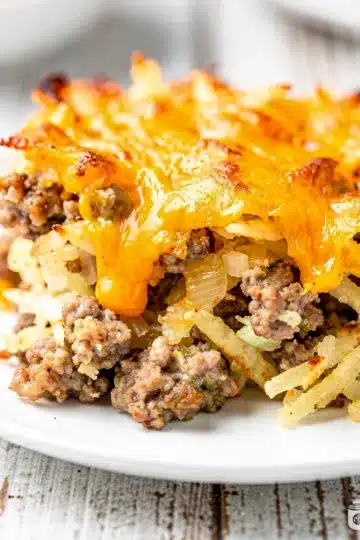 Easy Crockpot Sausage Hashbrown Casserole 6 Creamy crockpot sausage hashbrown casserole with cheese and chives in dish
