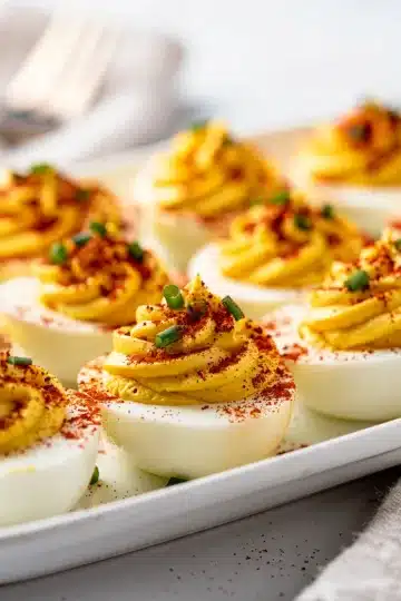 Classic Classic Deviled Eggs 11 Classic deviled eggs recipe with creamy filling and paprika chive garnish.