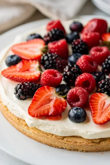 Easy Berry Cheesecake Fruit Pizza 13 Easy Berry Cheesecake Fruit Pizza with fresh fruit on a sugar cookie crust.