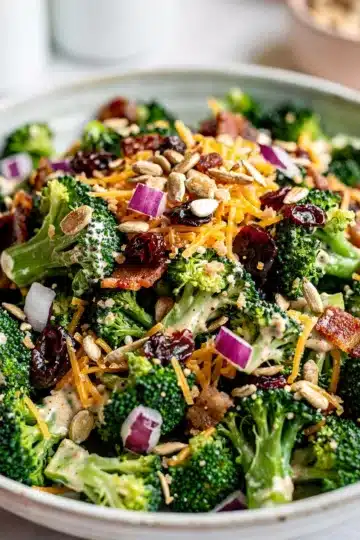 Fresh Broccoli Bacon Salad 11 Creamy broccoli bacon salad with cranberries and sunflower seeds in bowl
