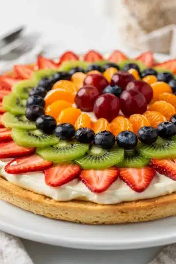 Creamy Classic Fruit Pizza 13 Classic fruit pizza with creamy frosting and fresh colorful fruit on sugar cookie crust