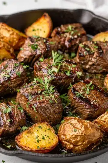 Skillet Garlic Butter Steak Bites and Potatoes 6 Skillet garlic butter steak bites and potatoes in creamy sauce close up