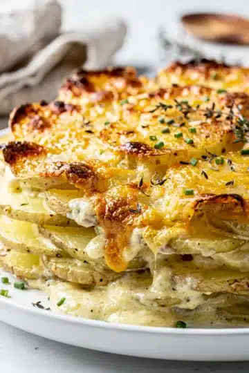 Classic Garlic Parmesan Scalloped Potatoes 1 Classic Garlic Parmesan Scalloped Potatoes in a white ceramic baking dish.
