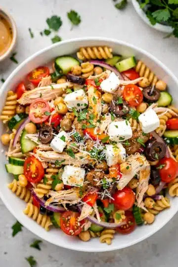 Easy High Protein Italian Pasta Salad 13 Easy high protein Italian pasta salad with chicken and vegetables in a bowl.