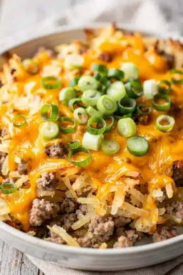 Homestyle Crockpot Sausage Hashbrown Casserole 4 Homestyle crockpot sausage hashbrown casserole with cheese and green onions.