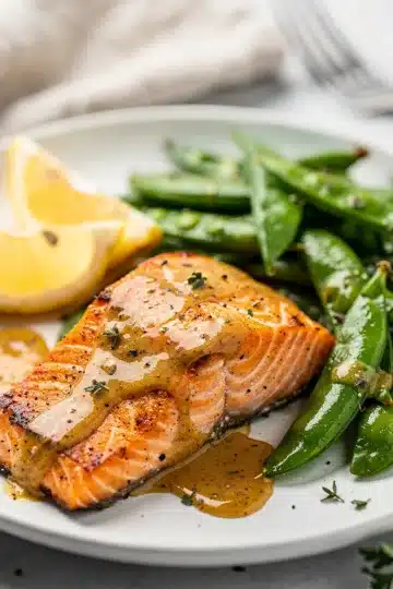 Honey Dijon Salmon with Snap Peas 2 Honey Dijon salmon with crisp snap peas in a vibrant close up photo