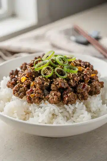 Homestyle Korean Ground Beef Bowl 11 Homestyle Korean ground beef bowl with rice, scallions, and sesame seeds.