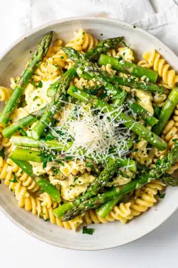Lemon Parmesan Asparagus Pasta Salad 12 Lemon parmesan asparagus pasta salad in a white ceramic bowl.