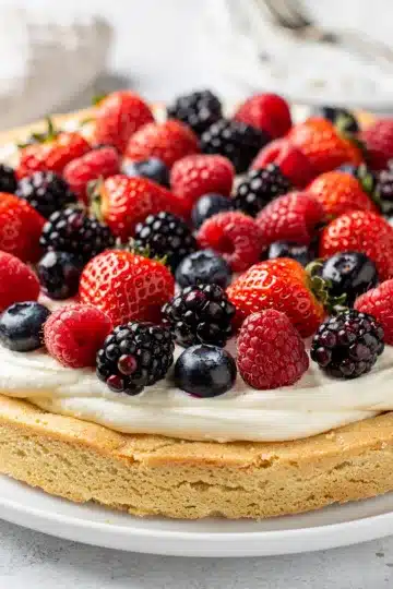 Old Fashioned Berry Cheesecake Fruit Pizza 10 Homemade berry cheesecake fruit pizza with fresh strawberries blueberries raspberries and blackberries.
