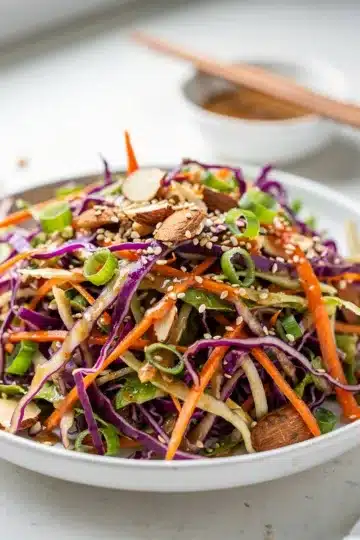Sesame Ginger Crunch Slaw Salad 9 Colorful sesame ginger slaw salad with crunchy almonds and ramen noodles