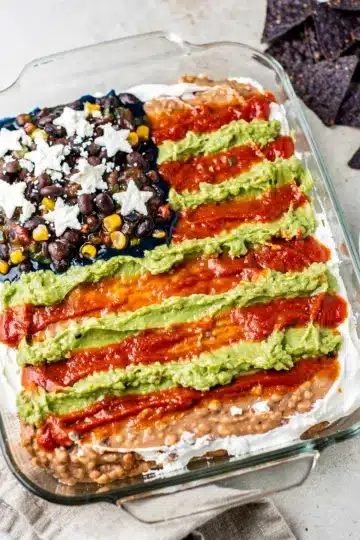 American Flag Layered Taco Dip 14 Patriotic layered taco dip recipe with vibrant salsa and creamy cheese layers