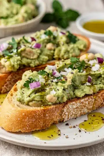 Avocado White Bean Bruschetta 11 Avocado and white bean bruschetta on toasted baguette slices with olive oil.